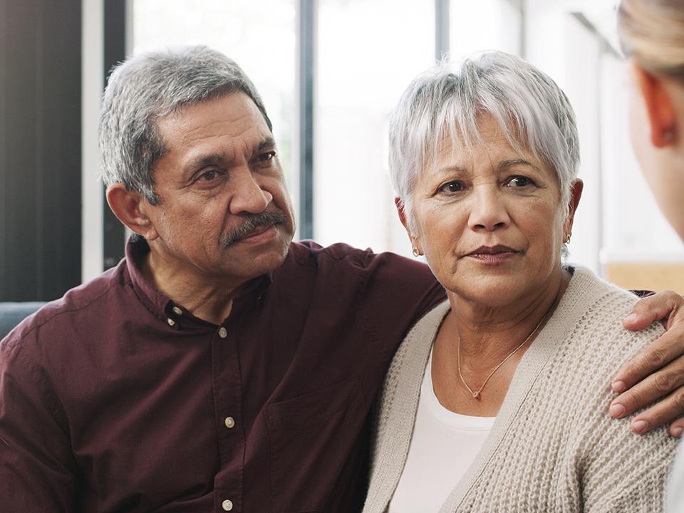 Older couple looks at out-of-frame woman